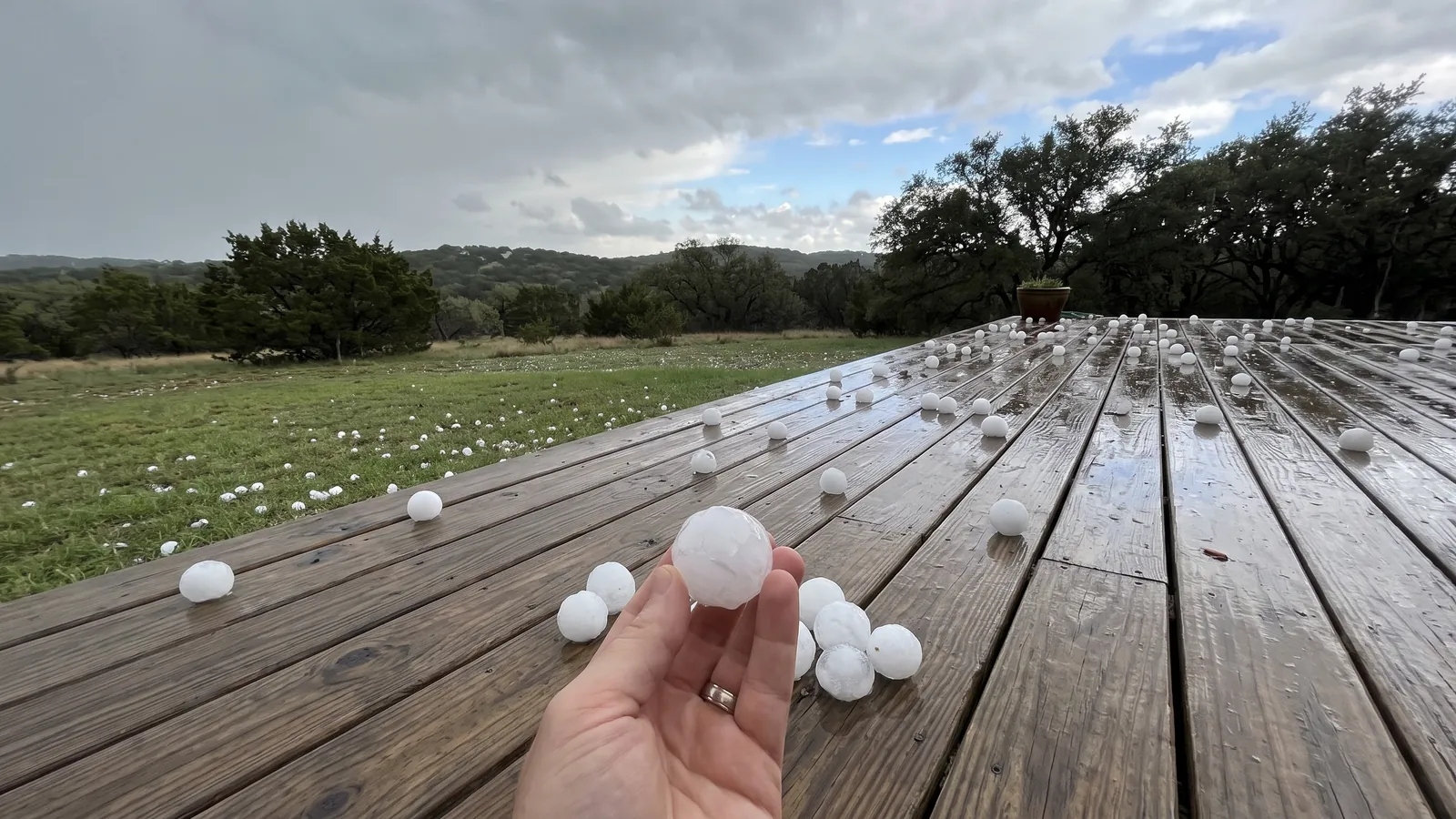 Ping-pong-ball-sized hailstones on a backyard deck after a spring storm in Comal County