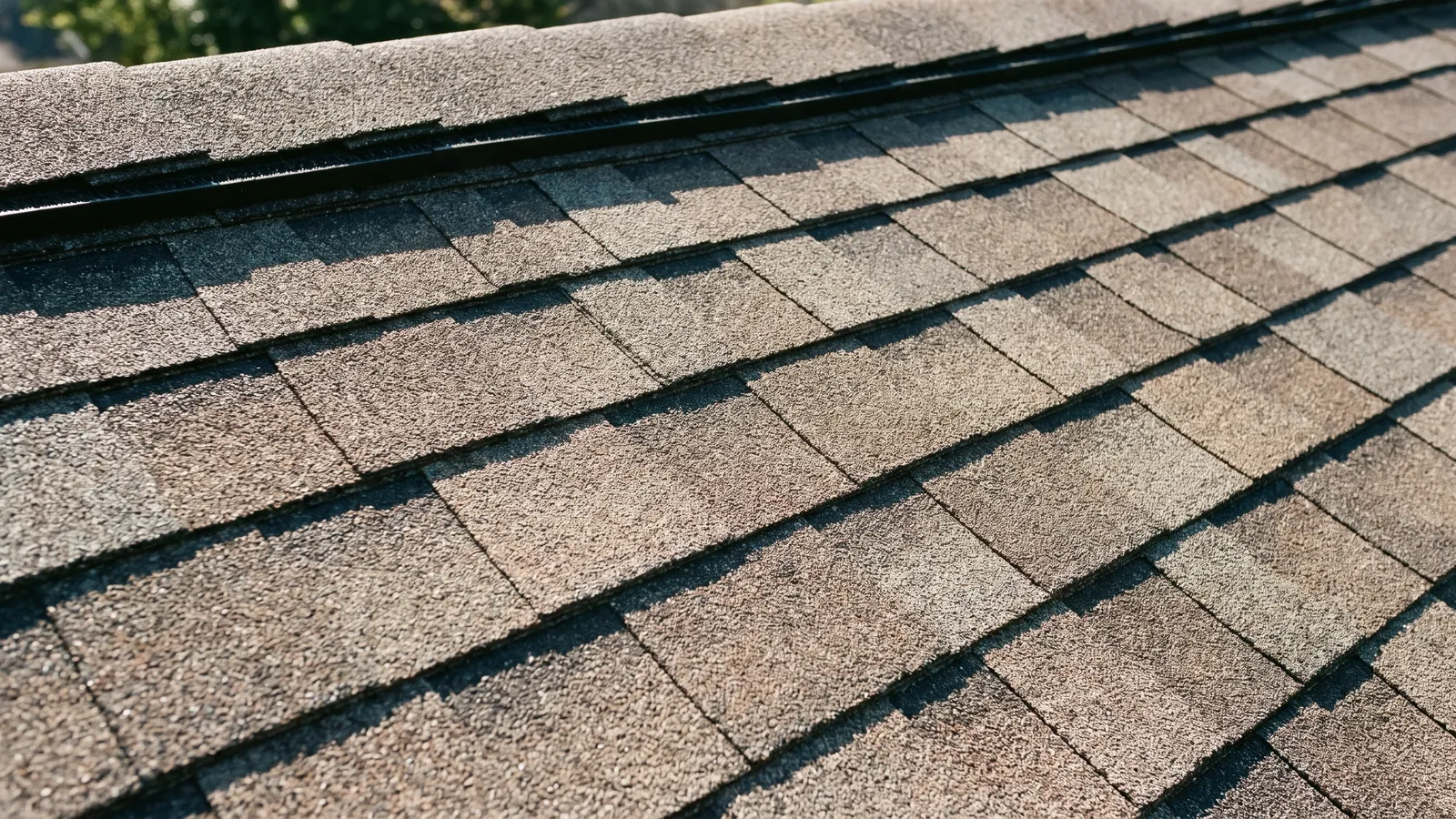 Close-up of new Class 4 impact-resistant architectural shingles in a weathered-wood color